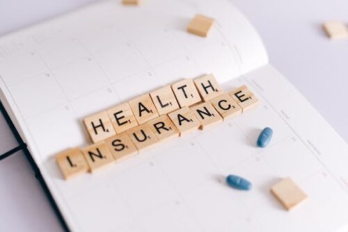 health insurance spelled out on notebook