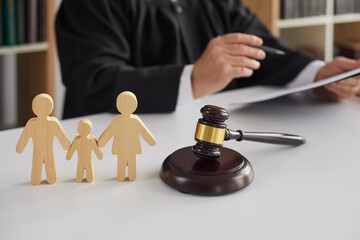 judge with gavel and cartoon family