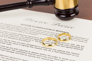 divorce decree with gavel and rings