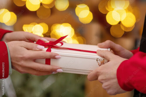 two peoples hands fighting over gift