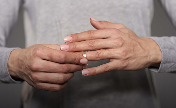 woman removing wedding ring