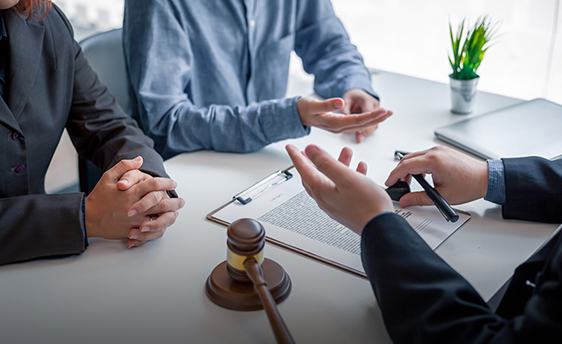 lawyer and clients speaking at a table